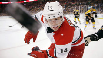 10ThingstoSeeSports - Carolina Hurricanes' Nathan Gerbe (14) battles for the puck in the first period of an NHL hockey game against the Boston Bruins in Boston, Saturday, March 15, 2014. (AP Photo/Michael Dwyer, File)