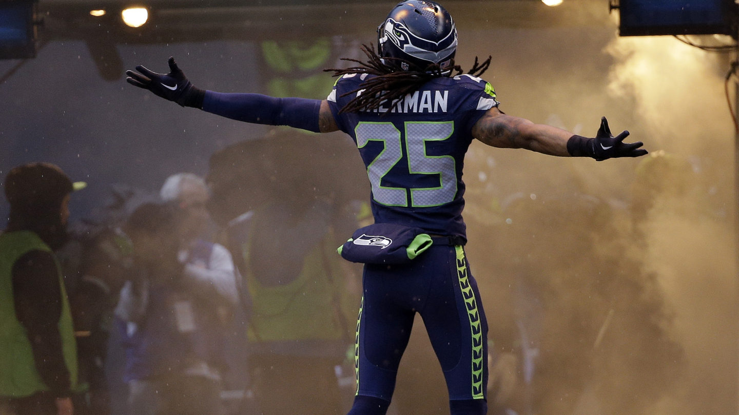 Seattle Seahawks' Richard Sherman opens his arms as he is introduced before the NFL football NFC Championship game against the Green Bay Packers Sunday, Jan. 18, 2015, in Seattle. (AP Photo/David J. Phillip)